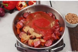 ingredients being combined to make a kielbasa bake