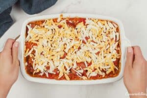 layering cheese over the filling for Louisiana Casserole prior to baking