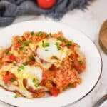 plate with a serving of Louisiana Casserole on a table ready to enjoy