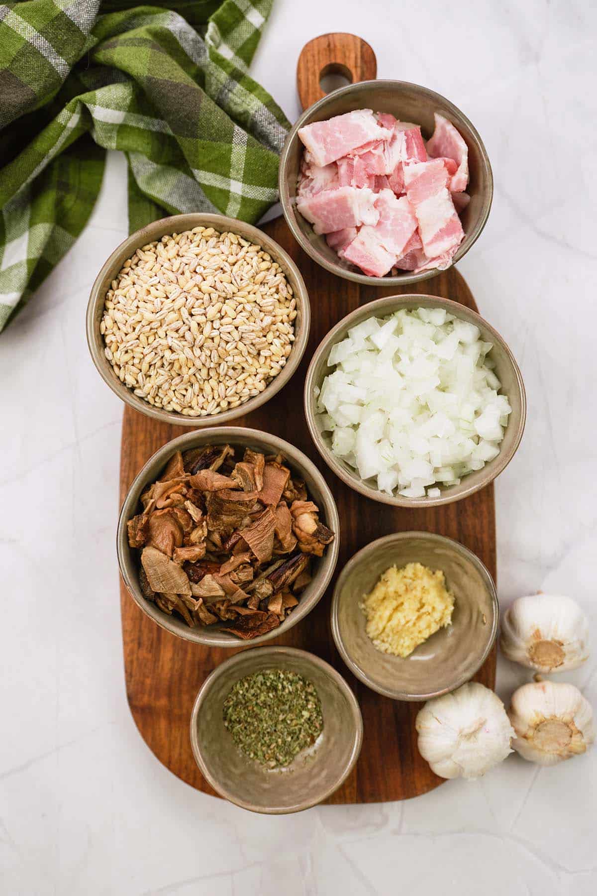 ingredients to make mushroom barley casserole laid out on a table