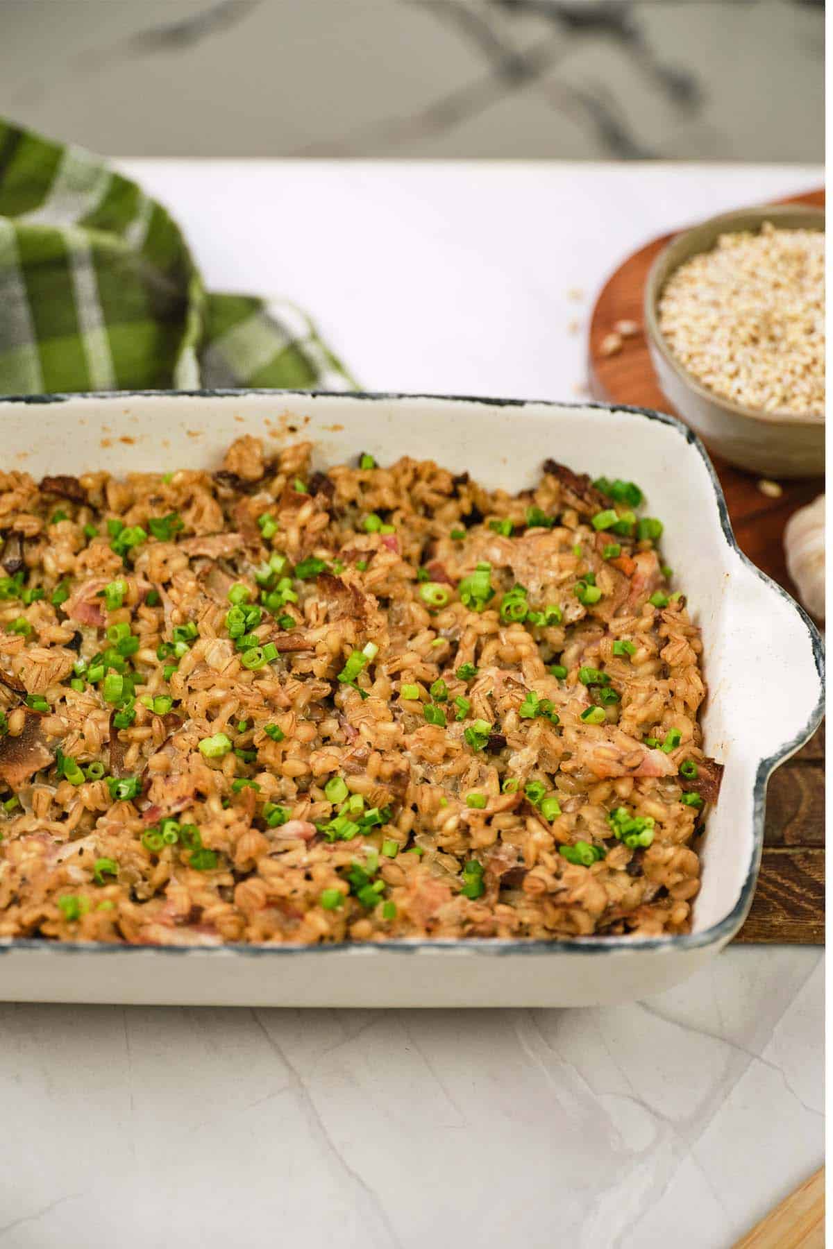 baking dish of mushroom barley casserole served on a table