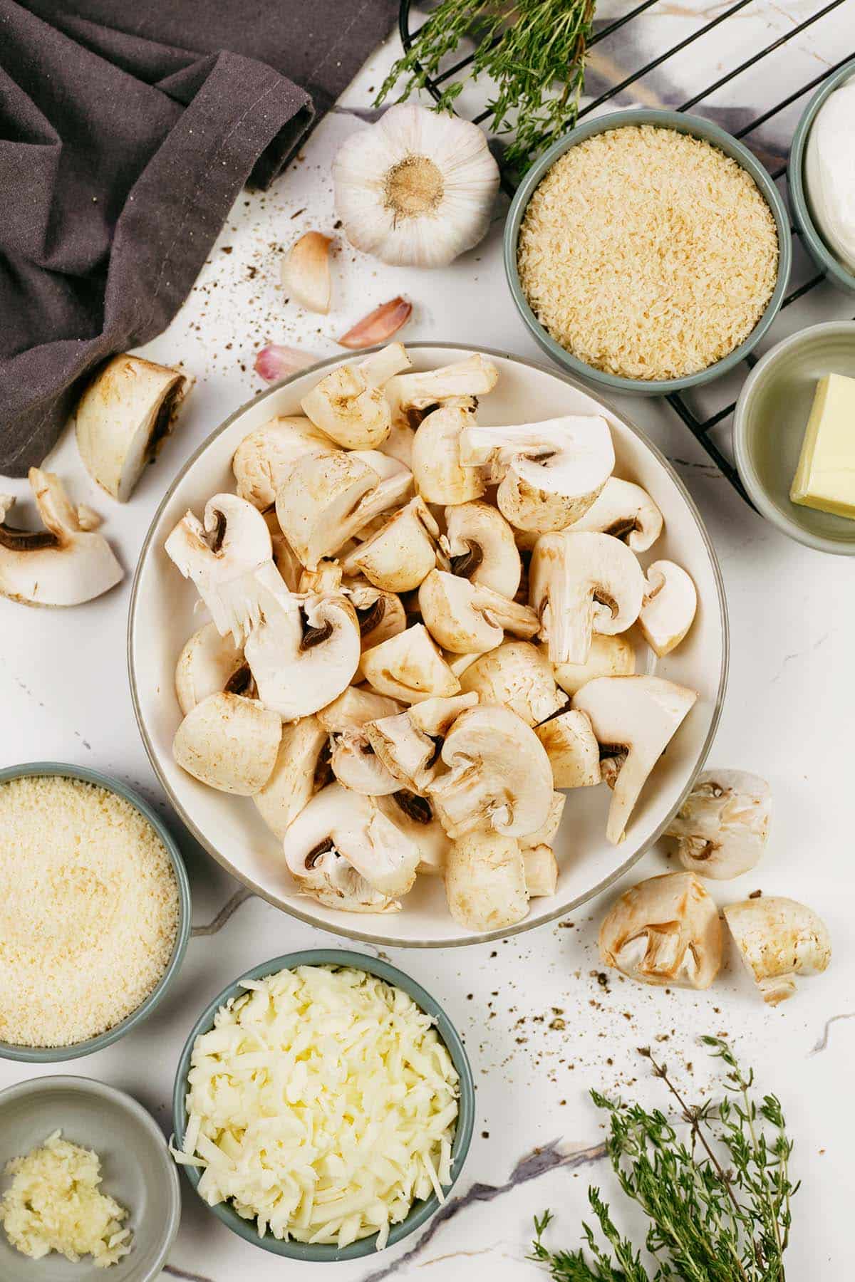 ingredients to make stuffed mushroom casserole laid out on a table