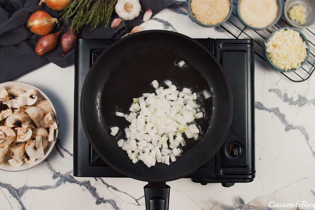 onions being sauteed to make stuffed mushroom casserole