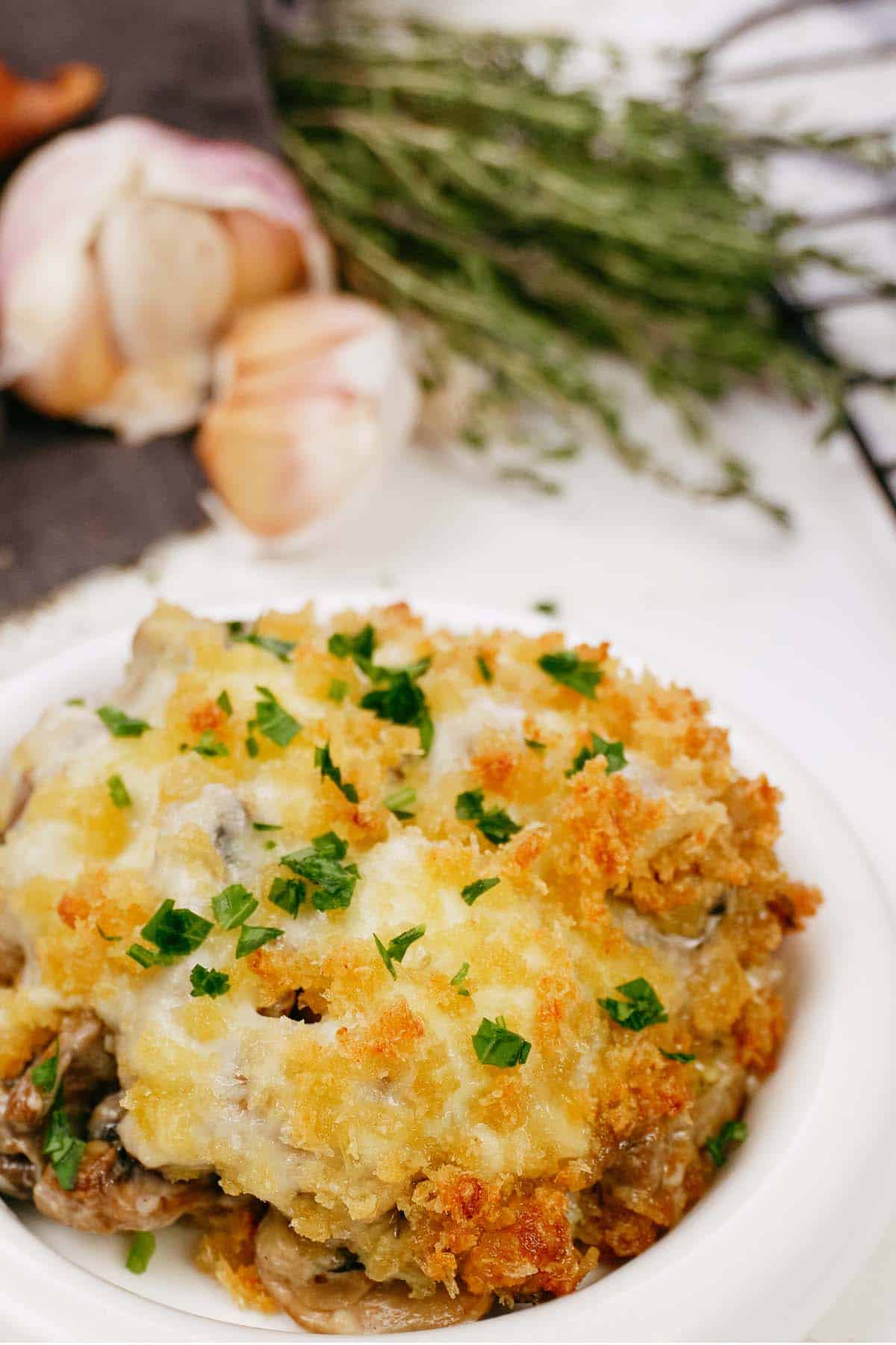 plate with a serving of stuffed mushroom casserole on a table ready to enjoy