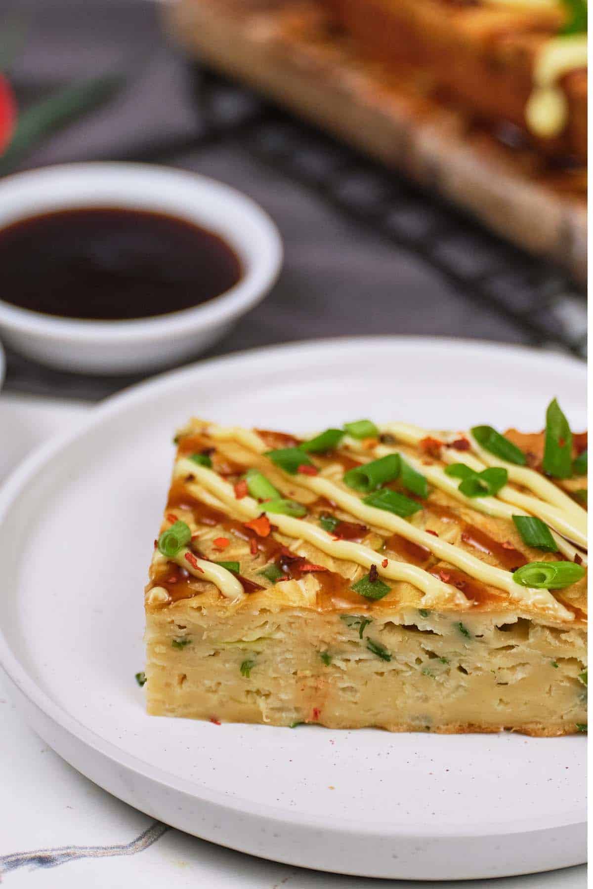 serving of Okonomiyaki bake on a plate ready to enjoy