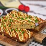 serving of Okonomiyaki bake being lifted using a spatula