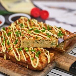 serving of Okonomiyaki bake being lifted using a spatula