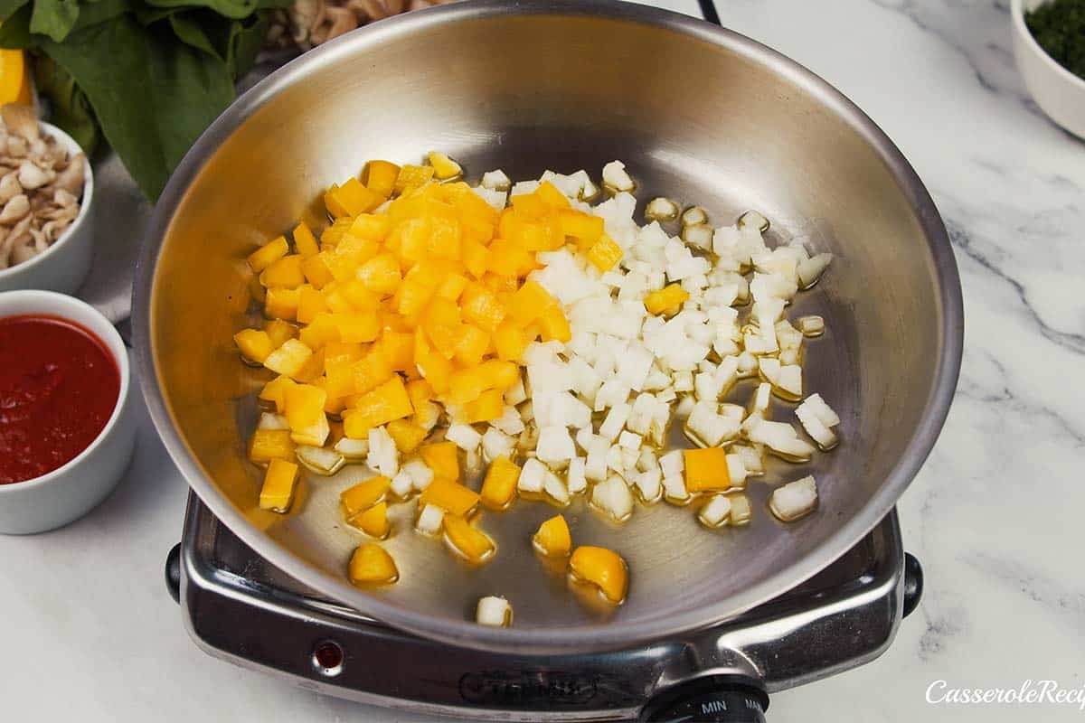 onions and bell pepper being sauteed to make Pizza Casserole with Couscous