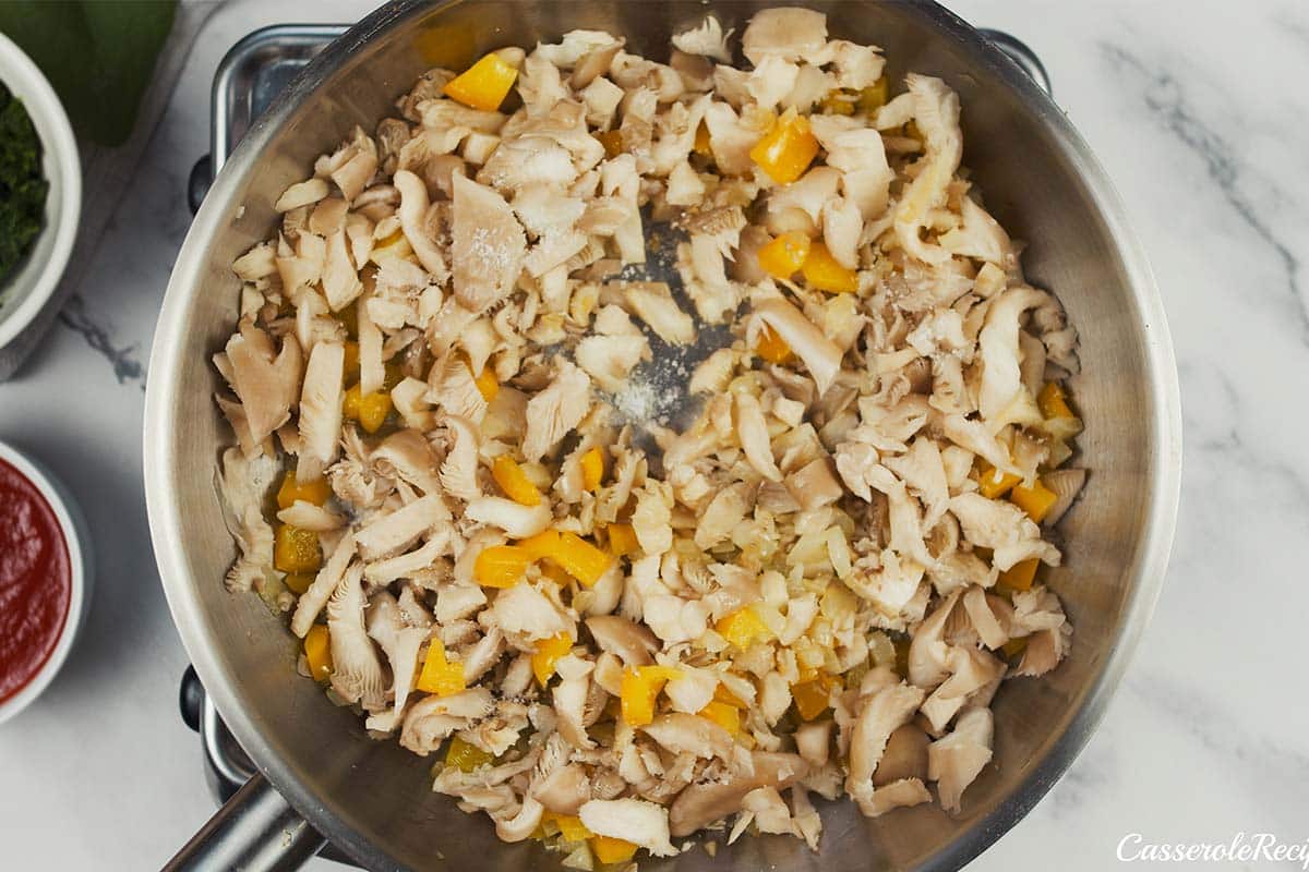 ingredients being combined in a saute pan to make Pizza Casserole with Couscous