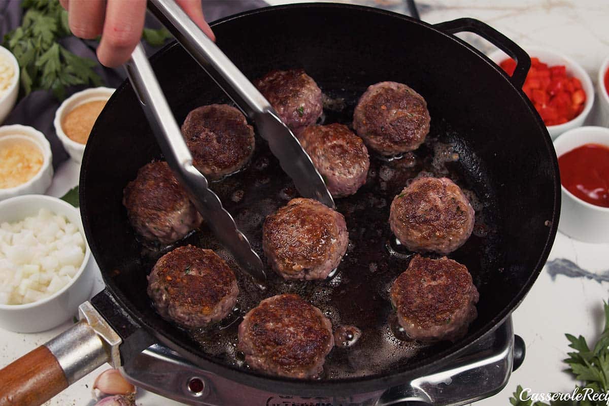 cooking meatballs to make Sloppy Joe Meatball Bake
