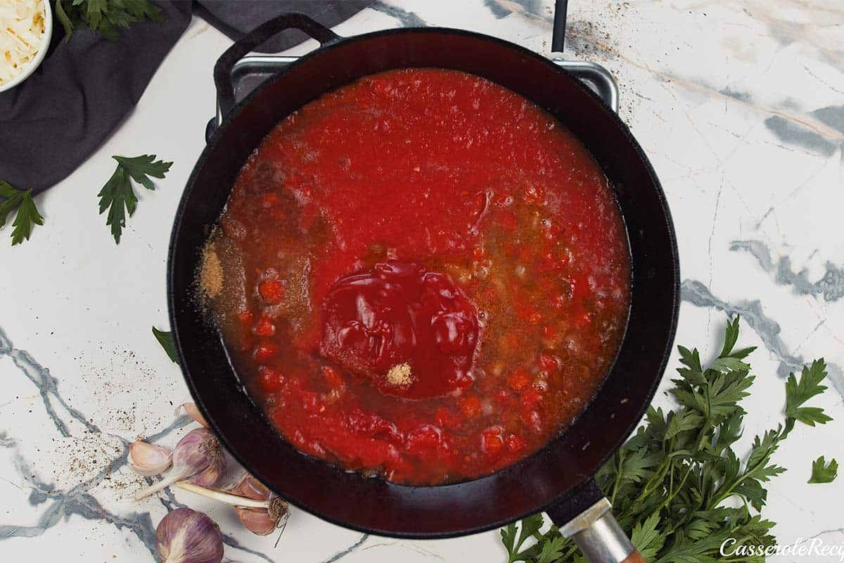 tomato sauce and other ingredients being stirred together to make the sauce for Sloppy Joe Meatball Bake