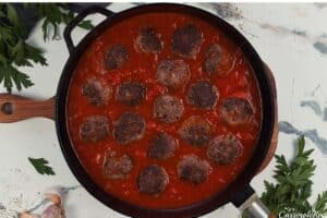 adding meatballs to the sauce to make Sloppy Joe Meatball Bake