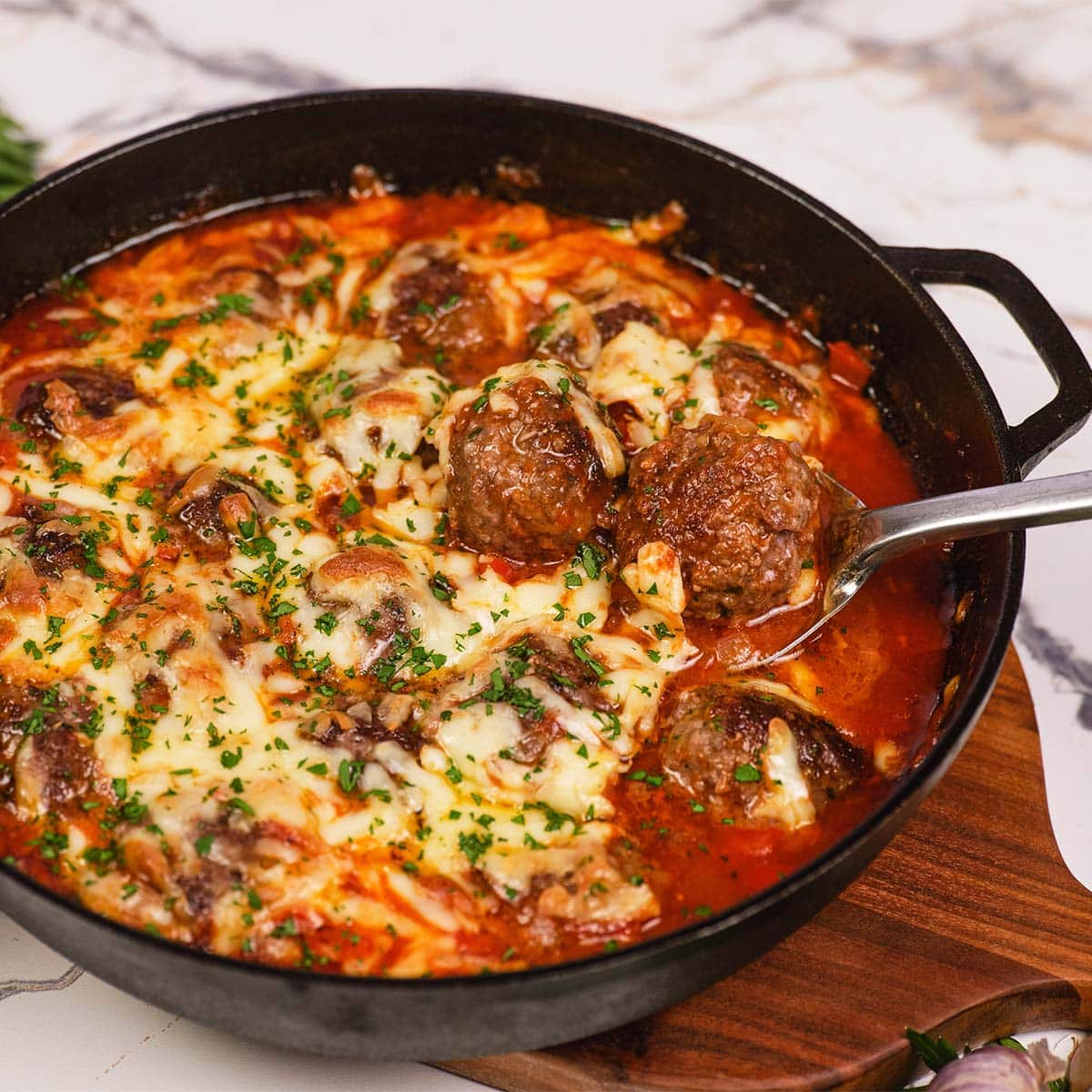 Sloppy Joe Meatball Bake being served from a cast iron skillet