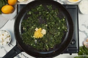 spinach being combined with other ingredients to make Spinach, Feta & Rice Casserole