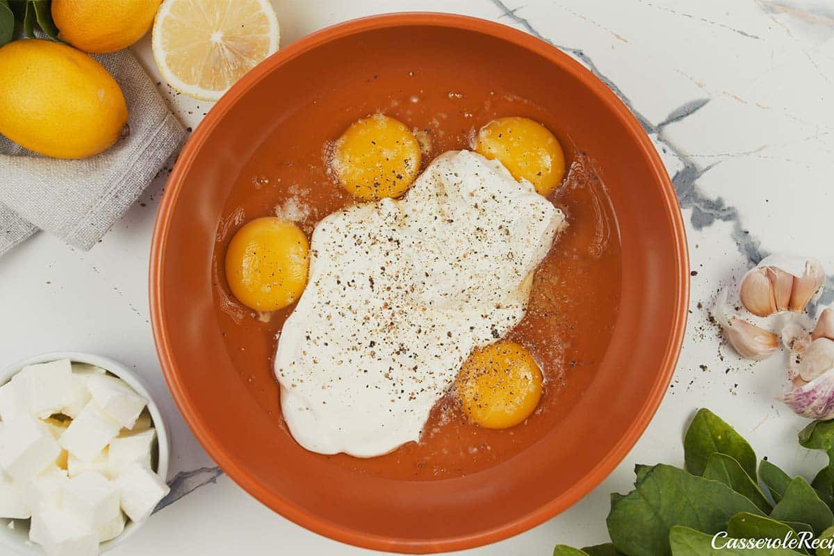 eggs being mixed with other ingredients to make Spinach, Feta & Rice Casserole