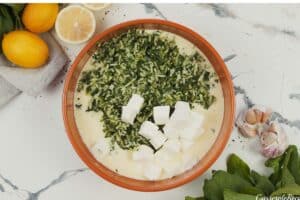 feta and spinach mixture being added to egg mixture to make Spinach, Feta & Rice Casserole