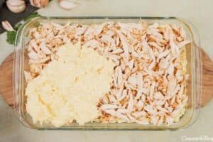layering ingredients in a baking dish to make Tah-Cheen (persian baked chicken and rice)