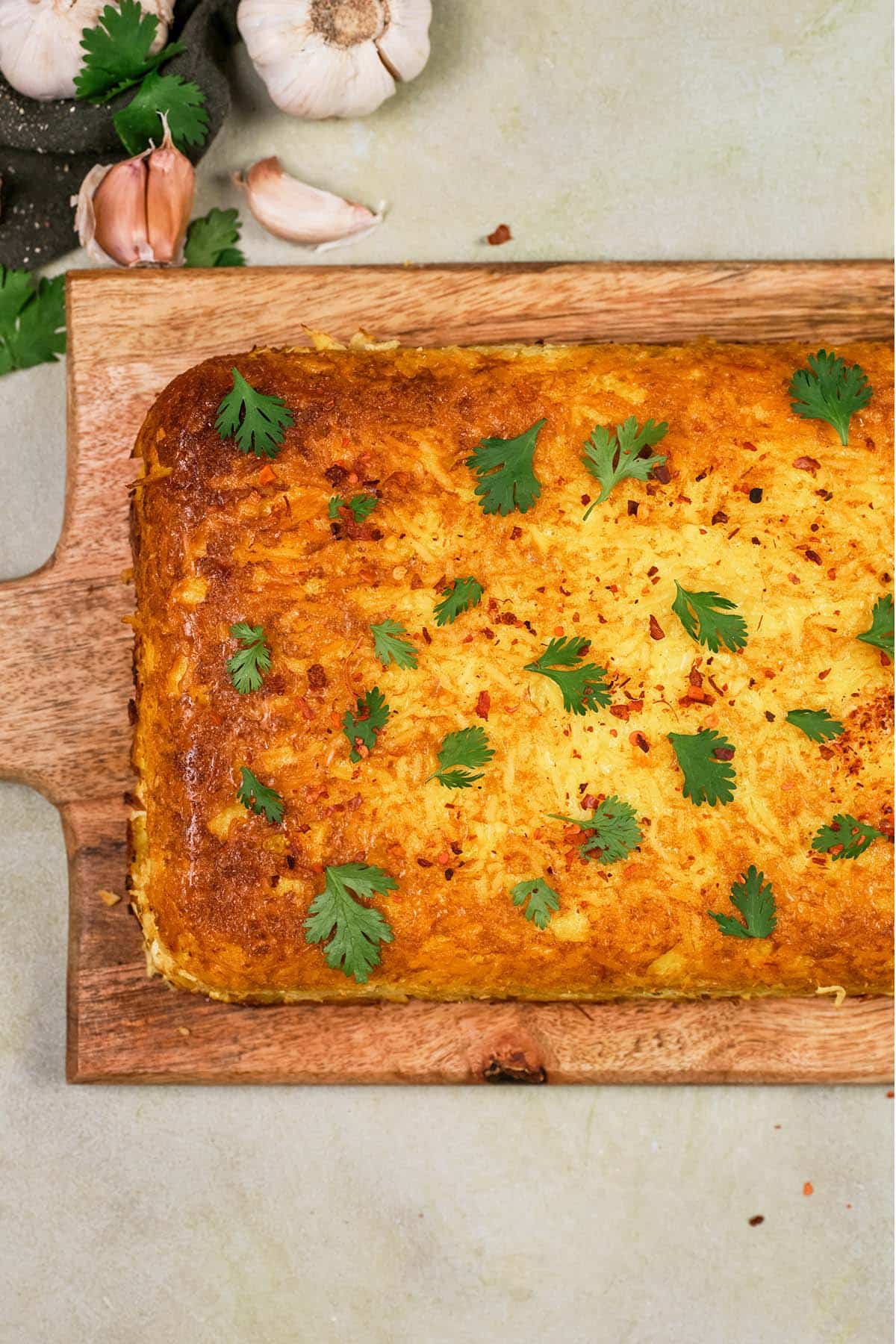 ready to serve Tah-Cheen (persian baked chicken and rice) on a wooden cutting board