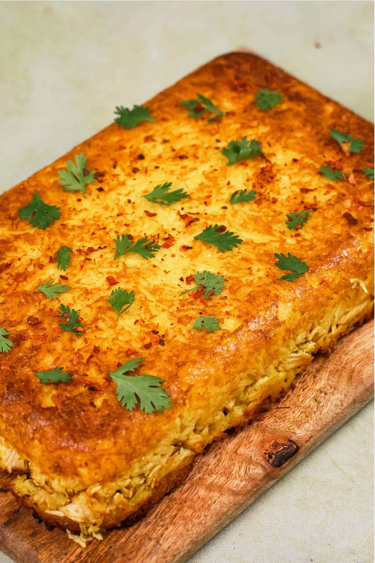Tah-Cheen (persian baked chicken and rice) on a cutting board fresh from the oven