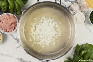onions being sauteed to make baked skillet lasagna