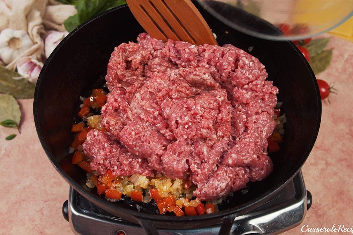 meat and other ingredients being cooked to make cheat lasagne bake
