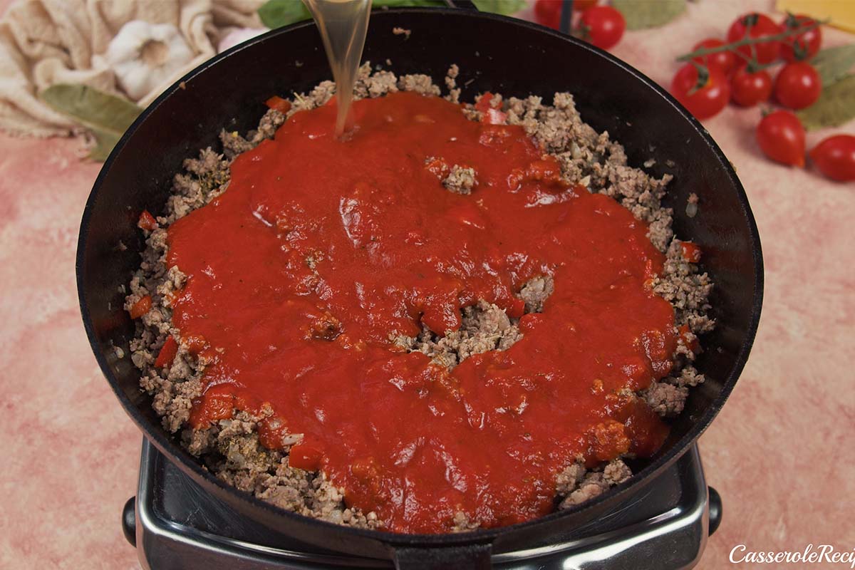 adding broth to make a sauce for cheat lasagne bake