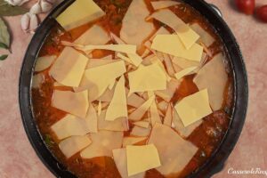 layering sliced cheese on top of filling for cheat lasagne bake