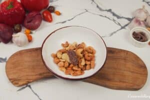 making cashew and anchovy topping for chicken bake with anchovy cashew