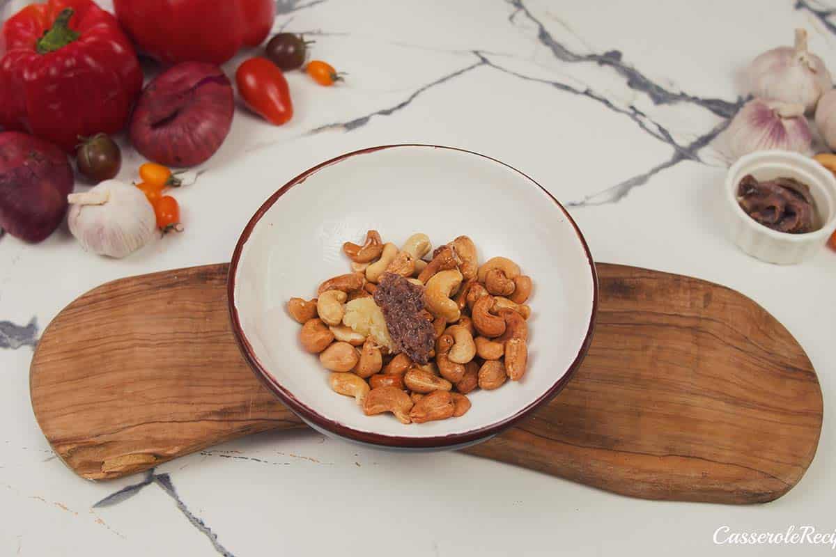 making cashew and anchovy topping for chicken bake with anchovy cashew