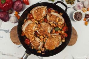 skillet of chicken bake with anchovy cashew prepared to be baked