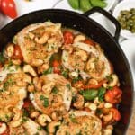cast iron dish of chicken bake with anchovy cashew
