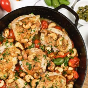 cast iron dish of chicken bake with anchovy cashew