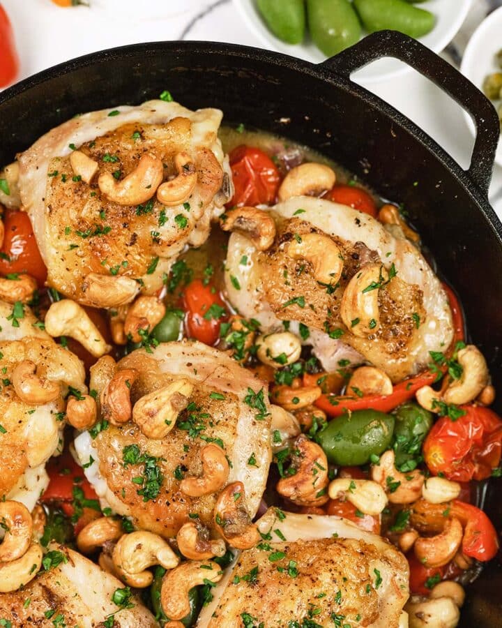 cast iron dish of chicken bake with anchovy cashew