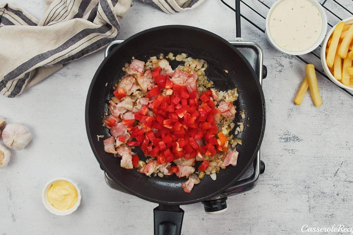 ingredients being sauted to make french fry casserole