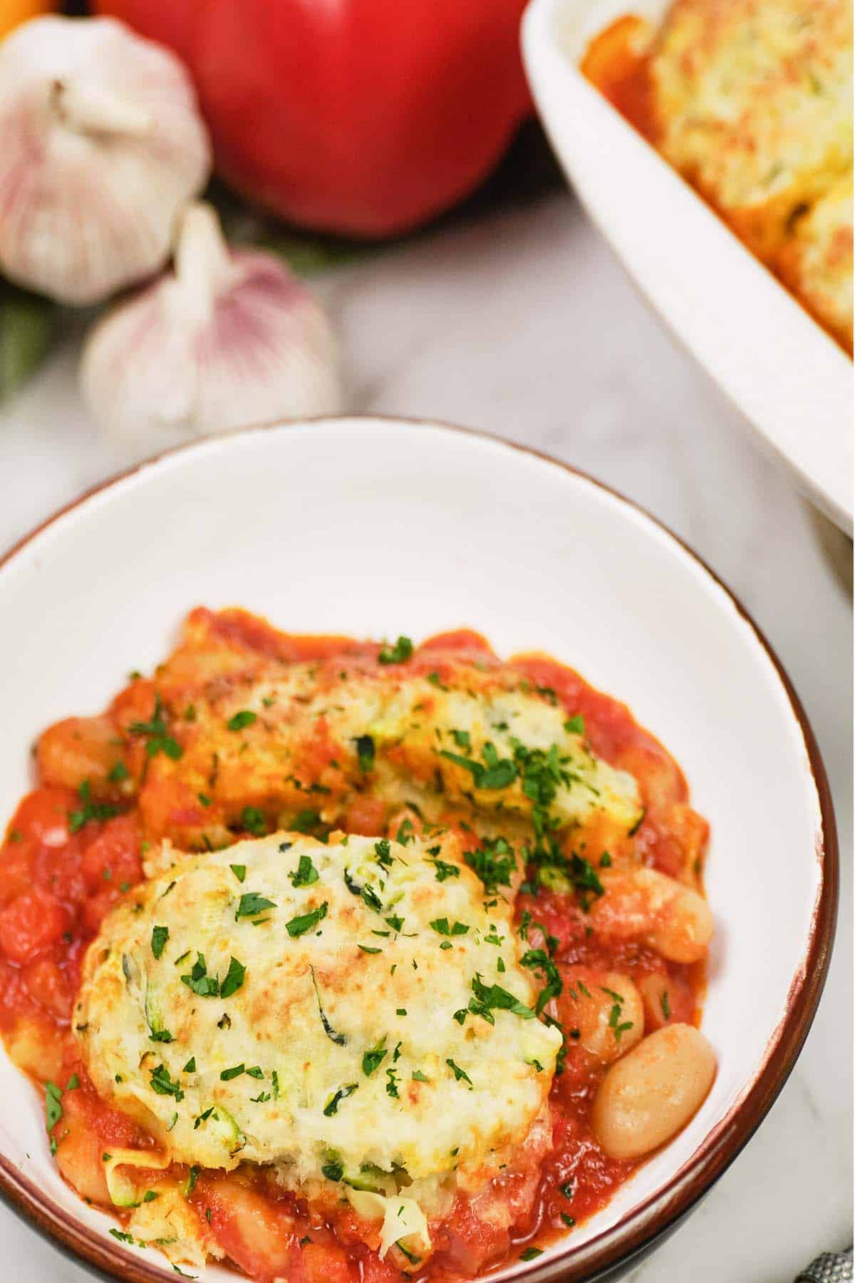 bowl of greek casserole with zucchini dumplings ready to enjoy