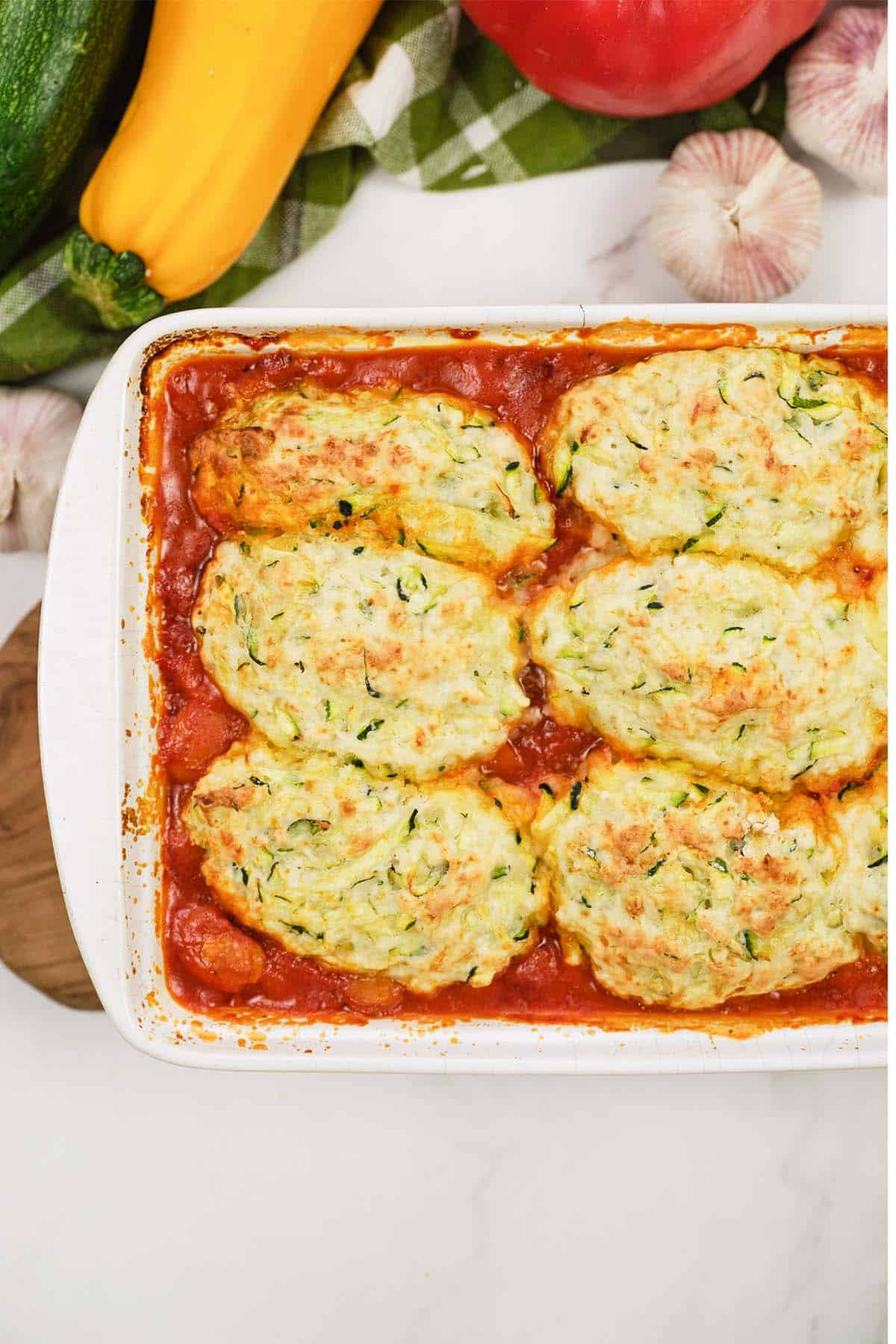 greek casserole with zucchini dumplings in a baking dish fresh from the oven