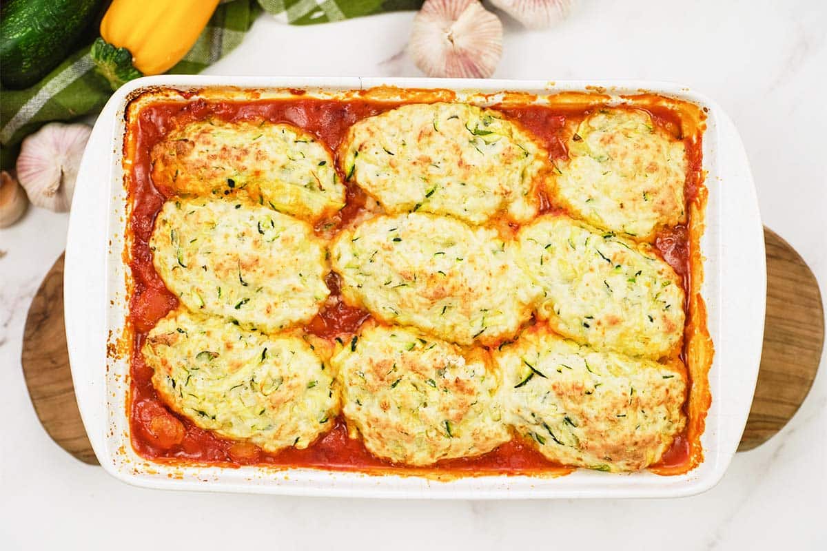 baking dish of greek casserole with zucchini dumplings fresh from the oven