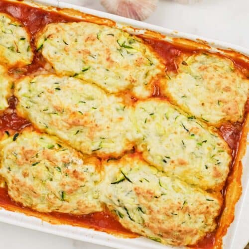 overhead view of greek casserole with zucchini dumplings in a baking dish