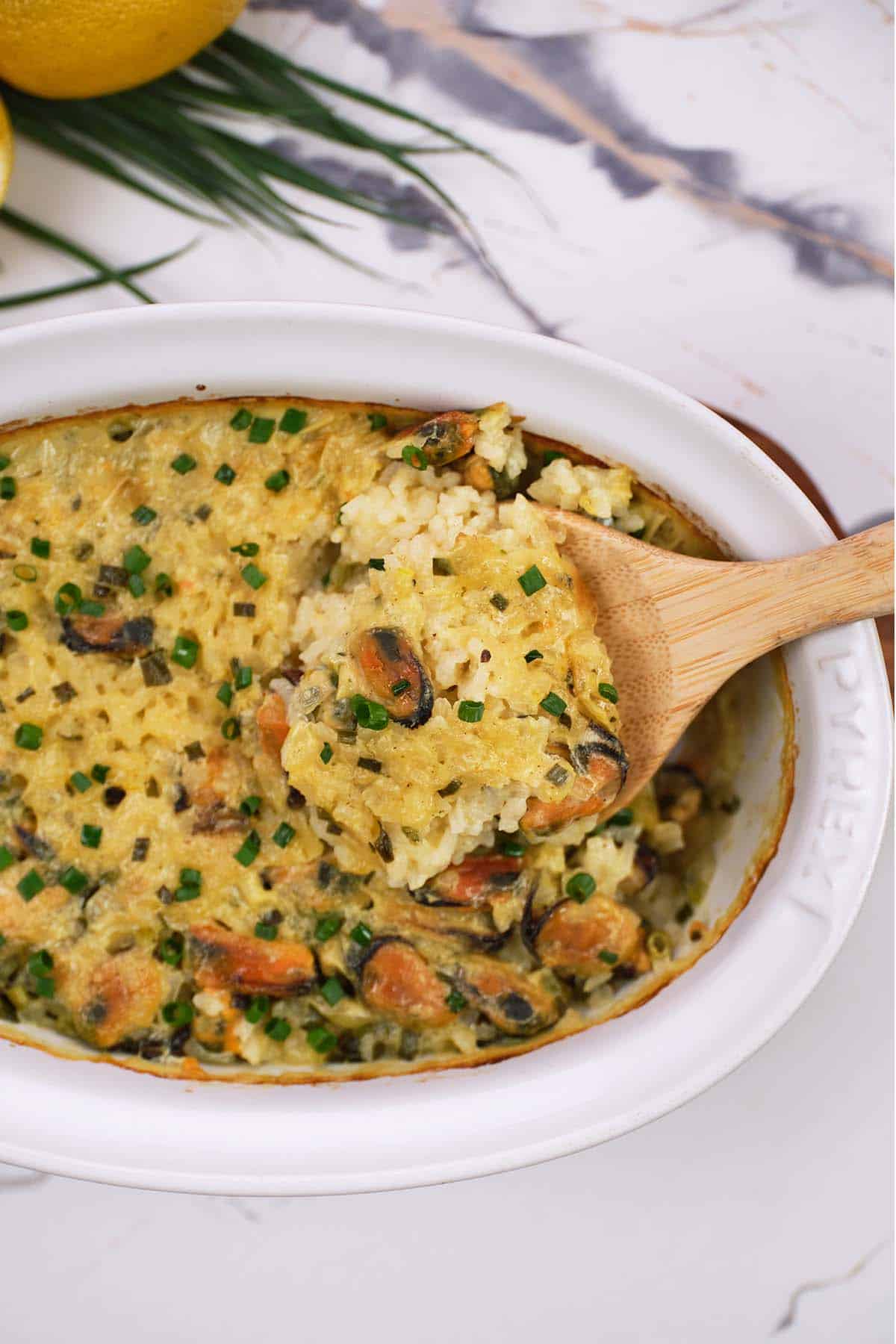 baking dish of greek rice and mussel casserole being served