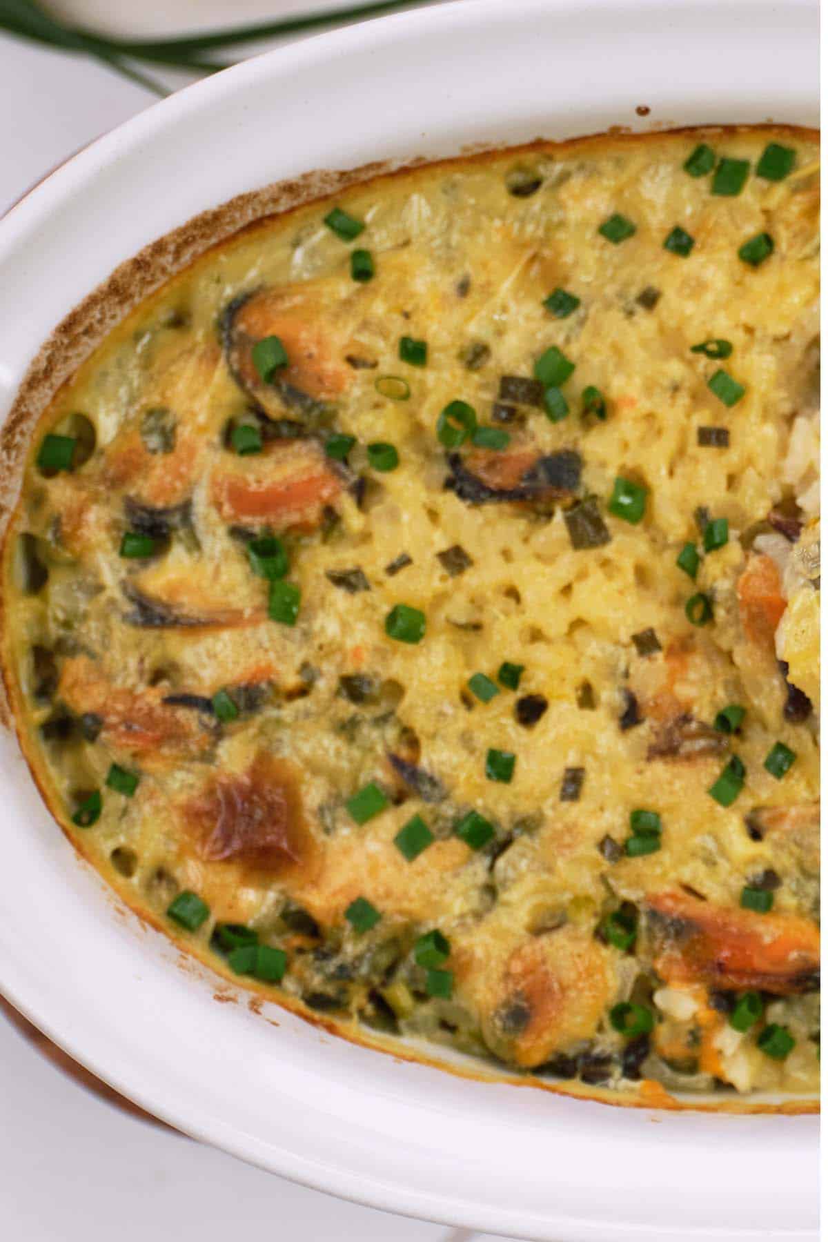 baking dish of greek rice and mussel casserole ready to serve