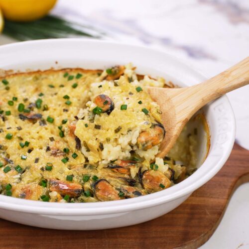 baking dish fresh from the oven of greek rice and mussel casserole being served