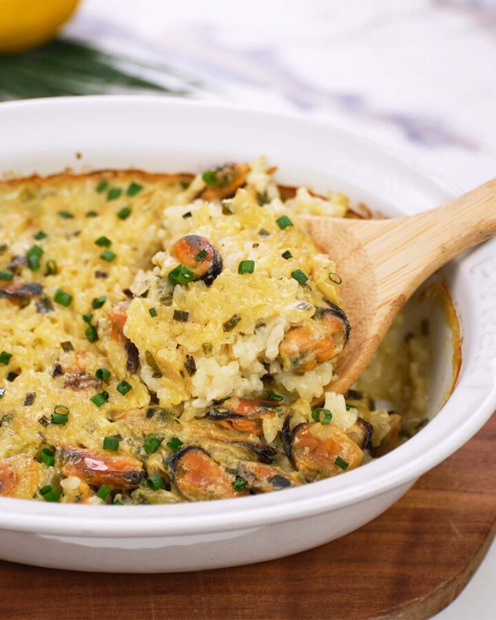 baking dish fresh from the oven of greek rice and mussel casserole being served
