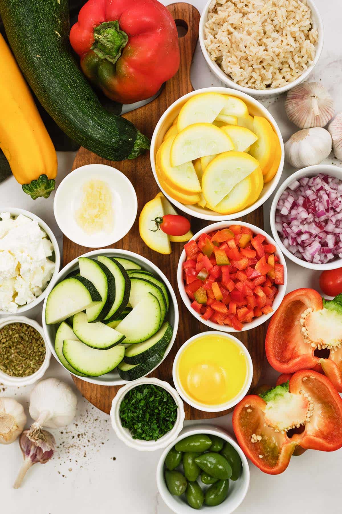 ingredients to make greek vegetable casserole laid out on a table