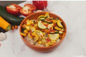 combining vegetables and other ingredients in a bowl to make greek vegetable casserole