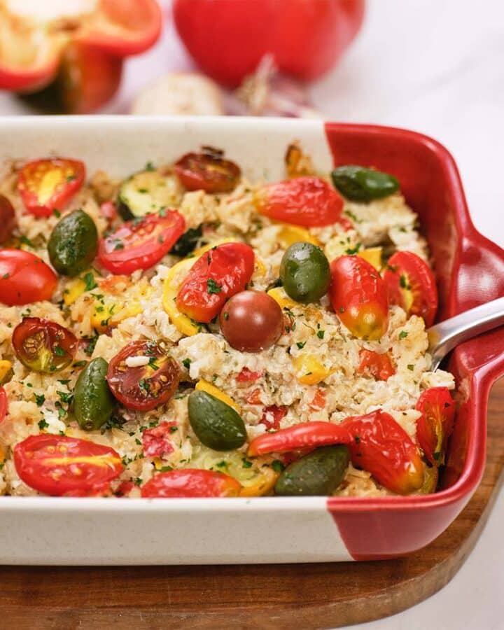 baking dish of greek vegetable casserole being served fresh from the oven
