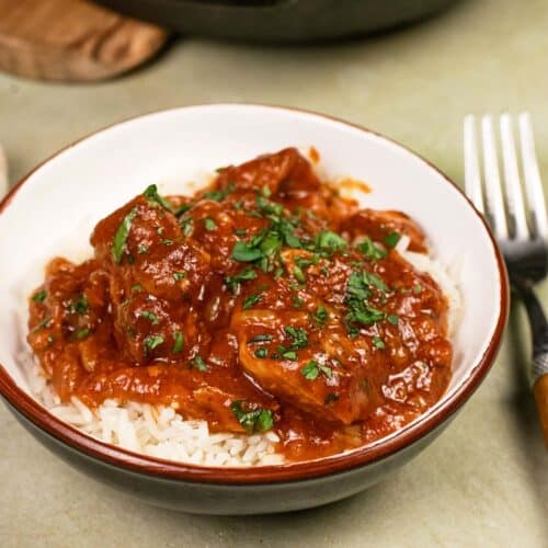 bowl with a single serving of kebab casserole served over rice ready to enjoy