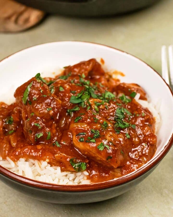 bowl with a single serving of kebab casserole served over rice ready to enjoy