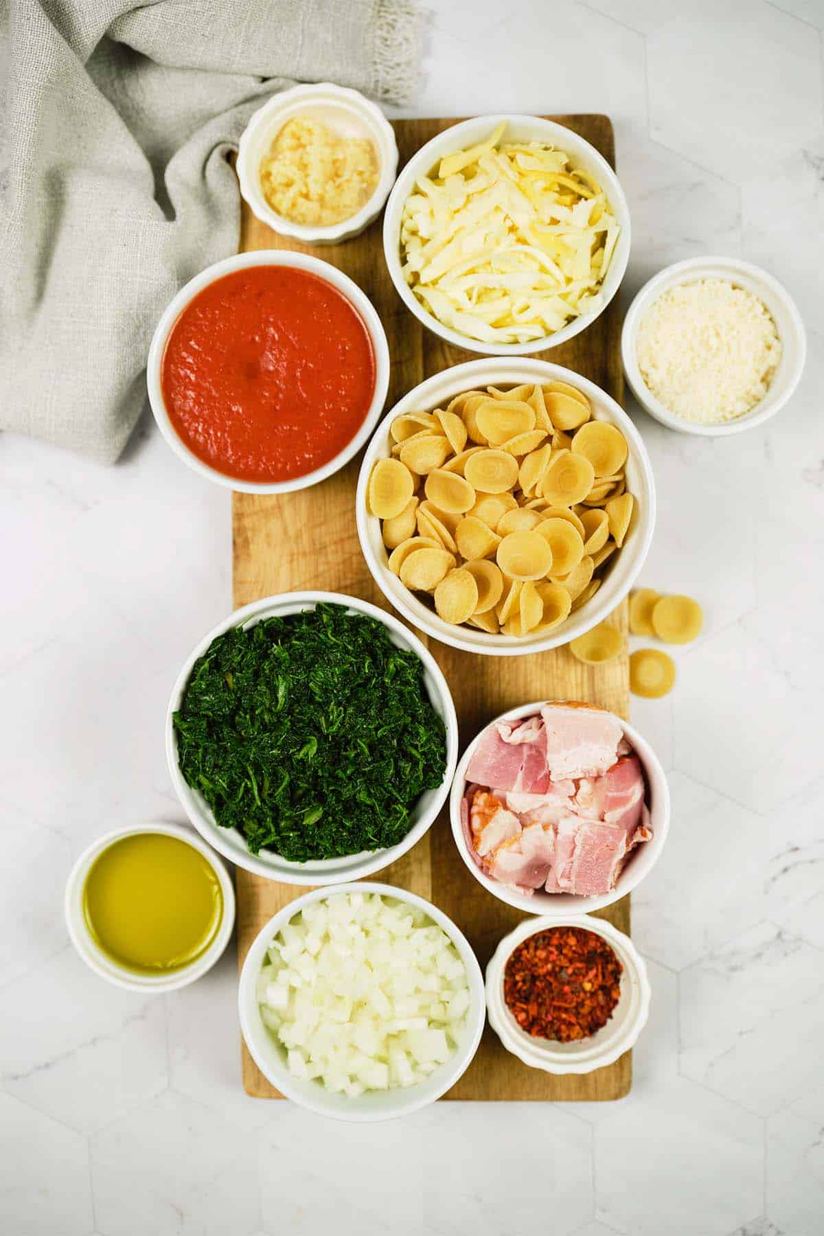 ingredients to make Baked Orecchiette with Spinach laid out on a table
