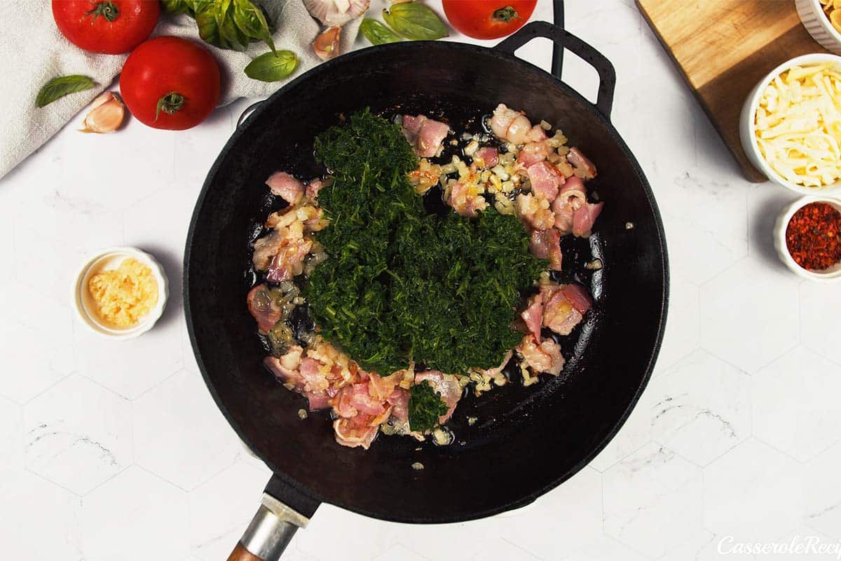 sauteeing spinach with other ingredients to make Baked Orecchiette with Spinach
