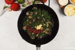 spinach and other ingredients being sauteed to make Baked Orecchiette with Spinach